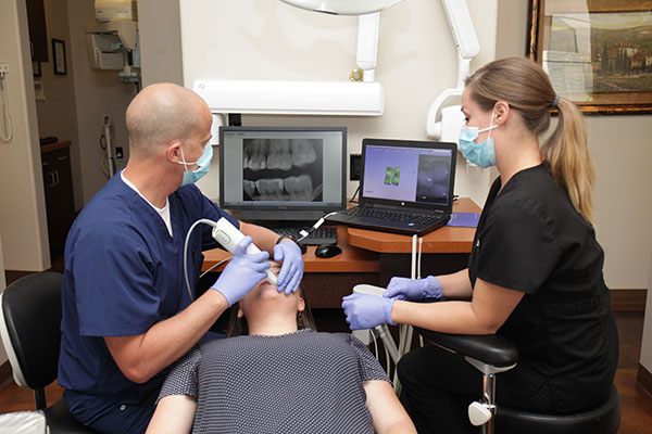 Doctor scanning a patients tooth